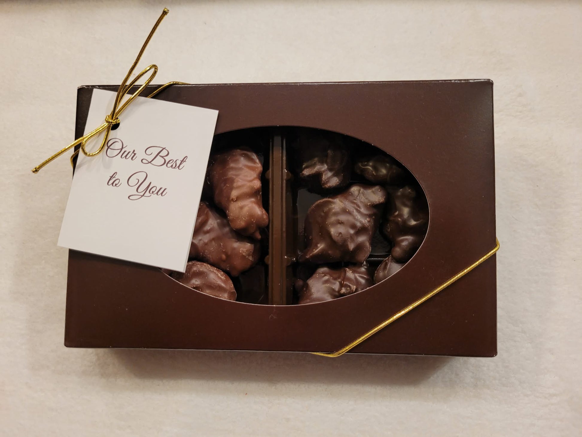 Close up of gift box of cashew clusters in Milk and dark chocolate